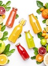 Citrus fruit juice bottles, food background. Summer drinks and beverages. Mix of different whole and cut fruits: orange,