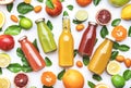 Citrus fruit juices, fresh and smoothies, food background, top view. Mix of different whole and cut fruits: orange, grapefruit, Royalty Free Stock Photo