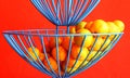 Citrus fruit oranges in blue wire basket. Royalty Free Stock Photo