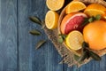 Citrus fruit. various citrus fruits with leaves of lemon, orange, grapefruit in a basket and orange juice on a blue wooden table. Royalty Free Stock Photo