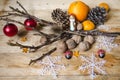 Citrus fruits, chocolate, nuts with cones and toys on boards