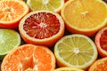 Citrus fruits cut in half, oranges, tangerines, yellow lemons, green limes, top view close-up, selective focus Royalty Free Stock Photo