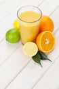 Citrus fruits and glass of juice. Oranges, limes and lemons Royalty Free Stock Photo