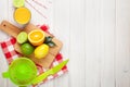 Citrus fruits and glass of juice. Oranges, limes and lemons Royalty Free Stock Photo