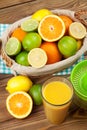 Citrus fruits and glass of juice. Oranges, limes and lemons Royalty Free Stock Photo