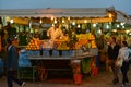 Citrus fruits juice stall with vendor in Djamaa El Fna square in Marrakesh, Morocco, Africa night scene