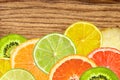 citrus fruits of lemon, orange, grapefruit, lime on wooden texture