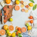 Citrus fruits slices over grey marble background, top view Royalty Free Stock Photo