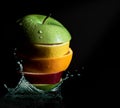 Citrus fruits splash orange, apple, lemon on dark background