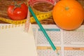 Citrus fruits, tomato. Measure tape and fresh fruit in the background. Healthy lifestyle diet with fresh fruits Royalty Free Stock Photo