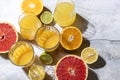 Citrus juice and fresh fruit, lime, grapefruit, orange, lemon in sunlight. Detox drink.