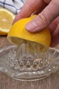 Make a lemon juice close-up with a citrus press Royalty Free Stock Photo