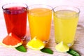 Citrus juices in glass - grapefruit, oranges and lime