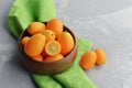 Citrus kumquat fruits in wooden bowl on linen cloth background. Healthy vegan food