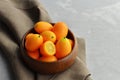 Citrus kumquat fruits in wooden bowl on linen cloth background. Healthy vegan food. Copy space Royalty Free Stock Photo