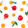Citrus with leaves and garnet fruits on white background. Flat lay. Top view