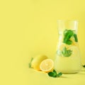 Citrus lemonade - mint, lemon and tropical monstera leaves on yellow background. Square crop. Detox drink. Summer fruit Royalty Free Stock Photo