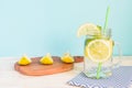 Citrus lemonade water with sliced lemon and mint, healthy and detox water drink in summer on wooden table with blue lighten Royalty Free Stock Photo