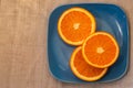 Citrus. A mandarin is served on a blue plate.