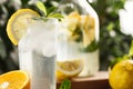 Citrus mint lemonade with ice cubes in glass Cup next to vintage carafe. Summer drink Limoncello Royalty Free Stock Photo