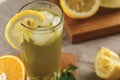 Citrus mint lemonade with ice cubes in glass Cup next to vintage carafe. Summer drink Limoncello Royalty Free Stock Photo