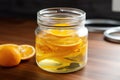 citrus peels soaking in jar of white vinegar