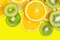 Citrus slices - kiwi, oranges and lemons on yellow background. Fruits backdrop Royalty Free Stock Photo