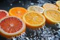 Citrus slices are splashing in water, including grapefruit, orange, and lemon