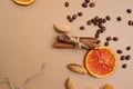 Citrus and spicy background with coffee beans and spices, warm ochre background.