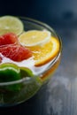 Citrus in water with bubbles in transparent plate Oranges, lemon