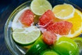 Citrus in water with bubbles in transparent plate Oranges, lemon