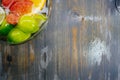 Citrus in water with bubbles in transparent plate Oranges, lemons, greyfrut