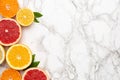 Citruses fruits on marble background with copyspace, fruit flatlay, summer minimal compositon with grapefruit, lemon, mandarin and Royalty Free Stock Photo