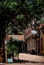 City alleyway, surrounded by tall brick buildings with trees growing in Skopje