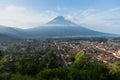 The city of Antigua in Guatemala adorned with its Agua volcano. Royalty Free Stock Photo
