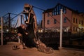 City attraction metal statue in old port of Klaipeda, Lithuania. Legend of black faceless ghost with lantern in hand