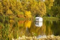 City autumn park, duck house on pond, picturesque golden season Royalty Free Stock Photo