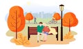 City autumn park landscape. People walk in the park, rides a bicycle, a couple in love sits on a bench. The guy hugs the