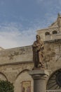 City of Bethlehem. The church Catherine next to the Basilica of the Nativity of Jesus Christ. Column with the figure of Saint Royalty Free Stock Photo