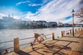 City bicycle with basket on the steering wheel of red color on the quay near the river Rhine in Switzerland against the backdrop o Royalty Free Stock Photo