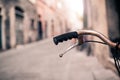 City bicycle handlebar, bike over blurred beautiful bokeh backgr Royalty Free Stock Photo