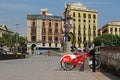 City bicycles stand in a row on a parking for rent against the background of the sculpture `Barcelona head` on the waterfront at t