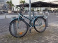 City bike without a saddle. A bicycle pinned to a lamppost in the city center. Stolen bicycle seat Royalty Free Stock Photo