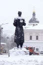 City after blizzard: the monument of Grigoriy Scovoroda covered with snow, church on a background Royalty Free Stock Photo