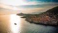 City and boat on the sea during sunset: Dubrovnik, Croatia at sunset Royalty Free Stock Photo