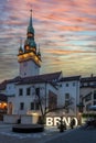 The city of Brno - a square which is illuminated by the inscription BRNO. In the background the church tower.