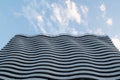 Wavy white building against the sky. Beautiful modern architecture. Royalty Free Stock Photo