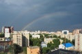 City buildings on the background of black sky with rainbow