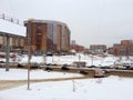 City, buildings, road and banner during winter time.