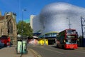 City bus in front of a modernist shopping mall